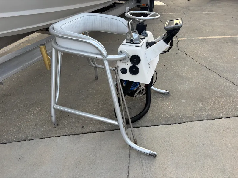 Slide: The Image of 1997 Jefferson Marlago 35 FS boat console with steering wheel and controls on pavement. - 3