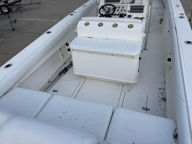Slide: The Image of 1997 Jefferson Marlago 35 FS boat interior with white seating and control panel. - 32