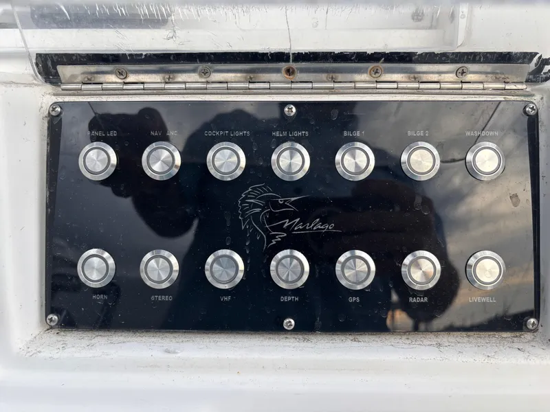 Slide: The Image of Control panel of a 1997 Jefferson Marlago 35 FS boat with labeled buttons. - 37