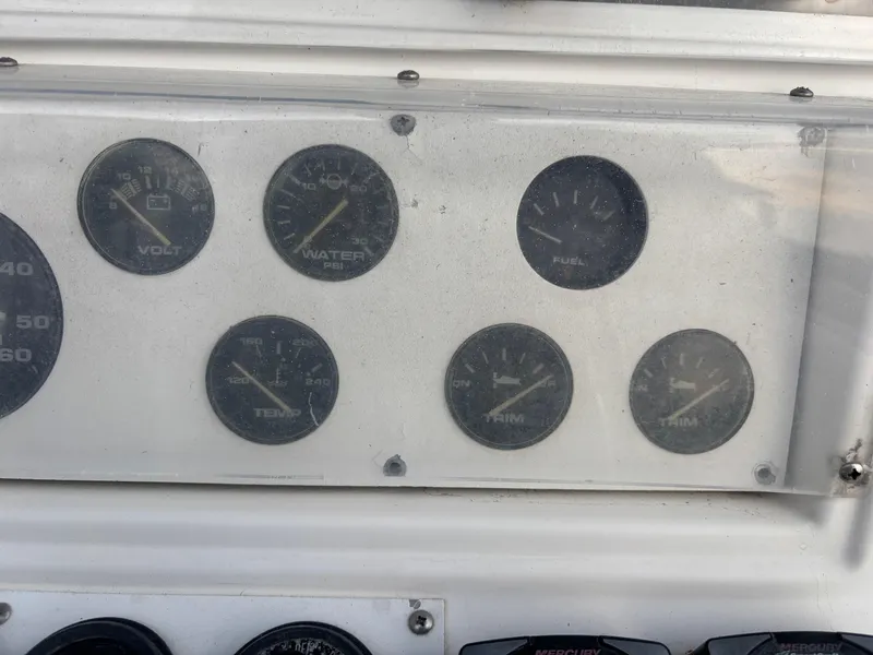 Slide: The Image of Dashboard gauges of a 1997 Jefferson Marlago 35 FS boat, showing volt, water, fuel, temp, and trim levels. - 38