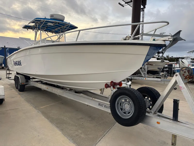 Slide: The Image of 1997 Jefferson Marlago 35 FS boat on trailer, parked outdoors under cloudy sky. - 6