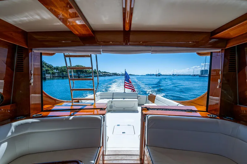 Slide: The Image of Hinckley Talaria 43 Flybridge 2019 yacht interior with ocean view and American flag. - 15