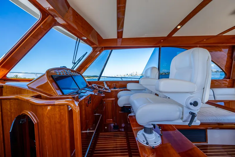 Slide: The Image of Interior of 2019 Hinckley Talaria 43 Flybridge with luxurious seating and wooden finishes. - 22