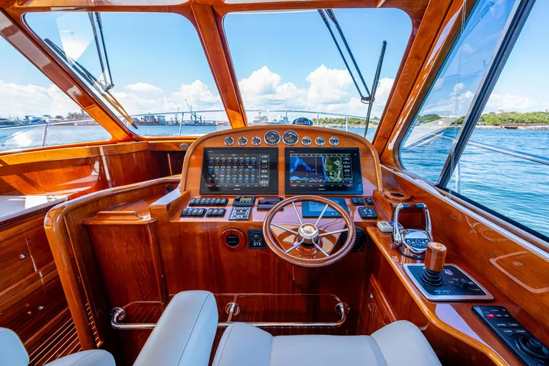 Slide: The Image of Luxurious 2019 Hinckley Talaria 43 Flybridge helm with polished wood and advanced navigation systems. - 25