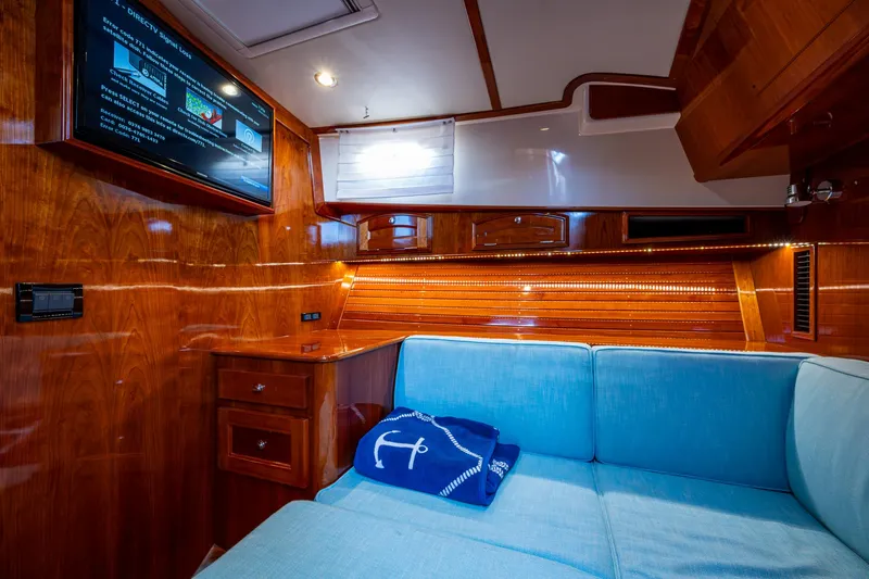 Slide: The Image of Luxurious interior of 2019 Hinckley Talaria 43 Flybridge with wood paneling and blue seating. - 34
