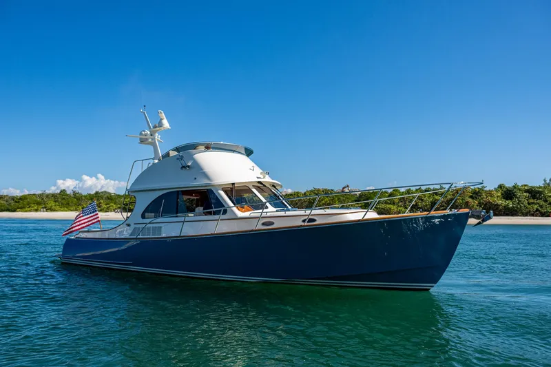 Slide: The Image of 2019 Hinckley Talaria 43 Flybridge yacht cruising on clear blue water. - 42