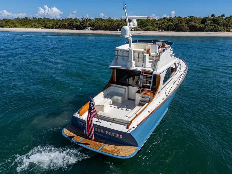 Slide: The Image of 2019 Hinckley Talaria 43 Flybridge yacht cruising near a tropical shoreline. - 5