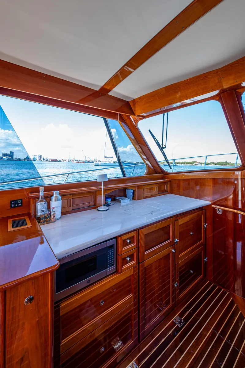 Slide: The Image of Luxurious interior of 2019 Hinckley Talaria 43 Flybridge yacht with wooden cabinetry and ocean view. - 18