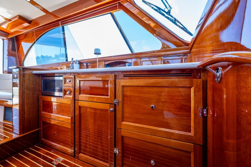 Slide: The Image of Luxurious wood interior of 2019 Hinckley Talaria 43 Flybridge yacht kitchen area. - 19