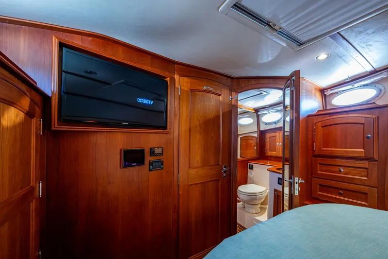 Slide: The Image of Luxurious 2019 Hinckley Talaria 43 Flybridge cabin with wood interior and modern amenities. - 27