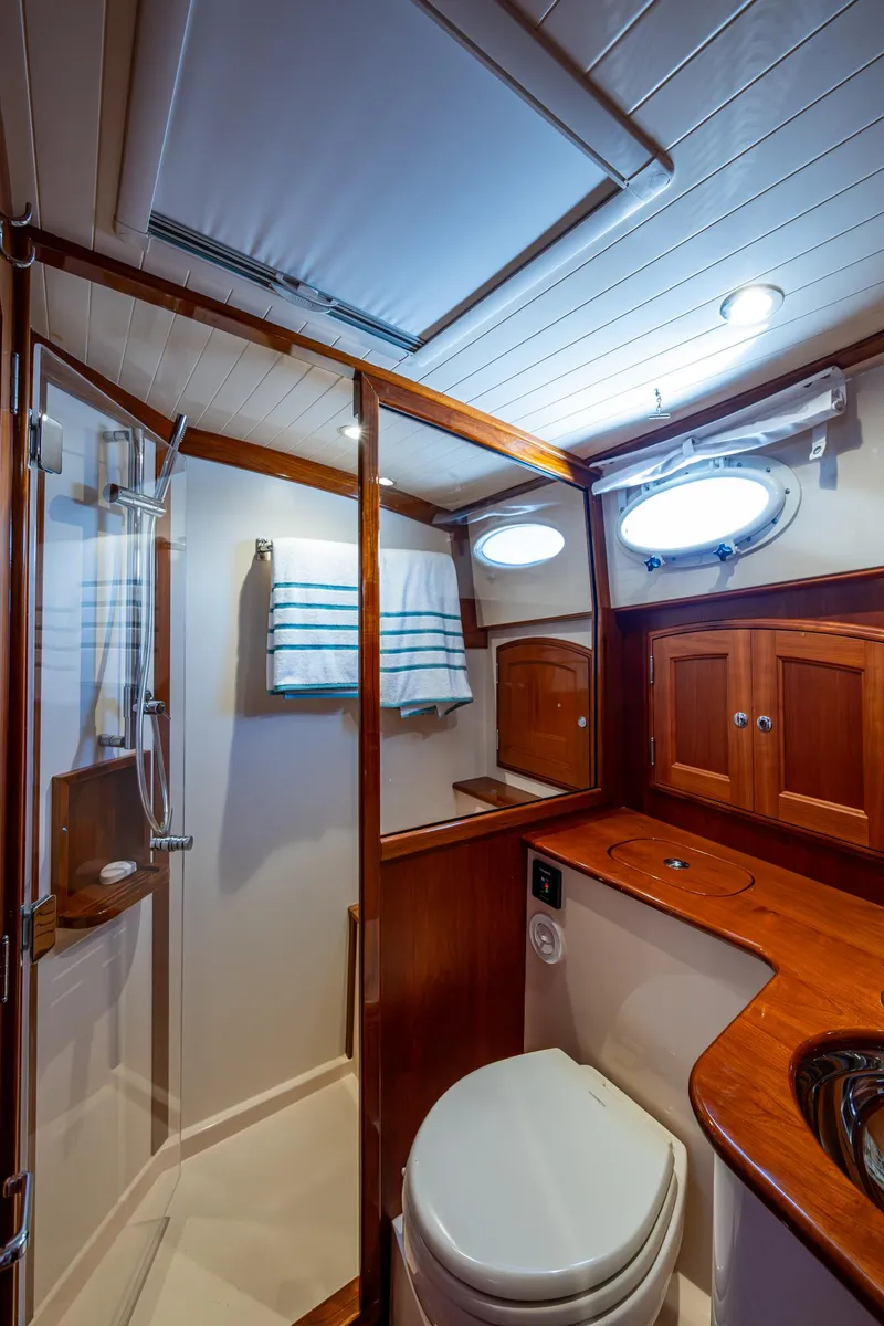 Slide: The Image of Luxurious 2019 Hinckley Talaria 43 Flybridge bathroom with wood accents and modern fixtures. - 32
