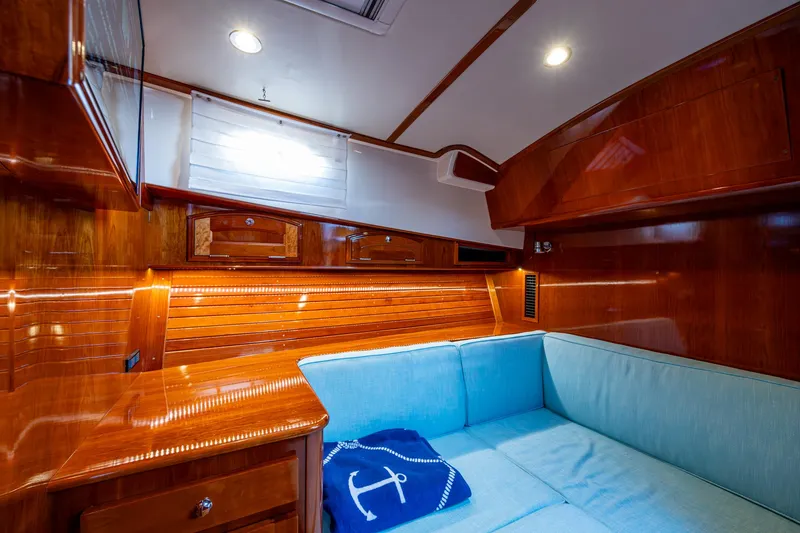 Slide: The Image of Luxurious 2019 Hinckley Talaria 43 Flybridge cabin with polished wood and cozy seating. - 33