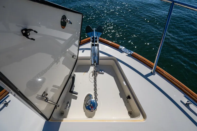 Slide: The Image of Anchor compartment of 2019 Hinckley Talaria 43 Flybridge yacht on water. - 37