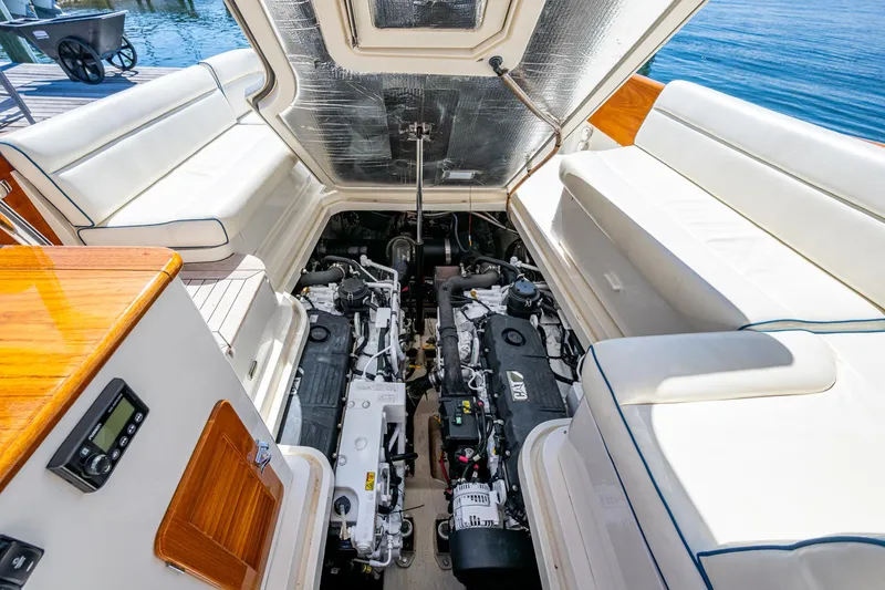Slide: The Image of 2019 Hinckley Talaria 43 Flybridge engine compartment with twin engines and luxurious seating. - 40