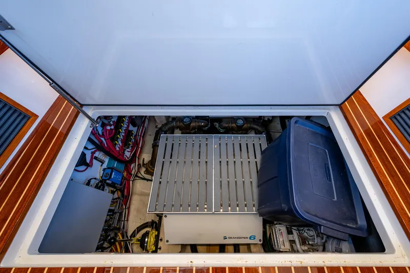 Slide: The Image of Engine compartment of 2019 Hinckley Talaria 43 Flybridge with storage and equipment. - 41