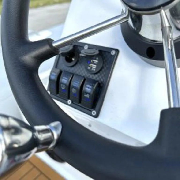 Slide: The Image of Steering wheel and control panel of 2024 EastMarine Godiac Elite 360 boat. - 3