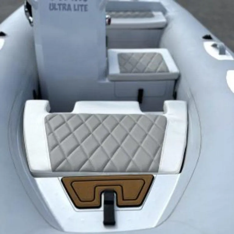 Slide: The Image of 2024 EastMarine Godiac Elite 360 boat interior with quilted seating and sleek design. - 8