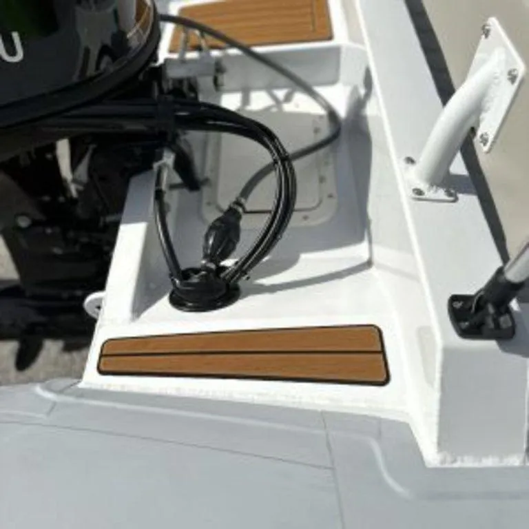 Slide: The Image of 2024 EastMarine Godiac Elite 360 boat detail with motor and deck features. - 9