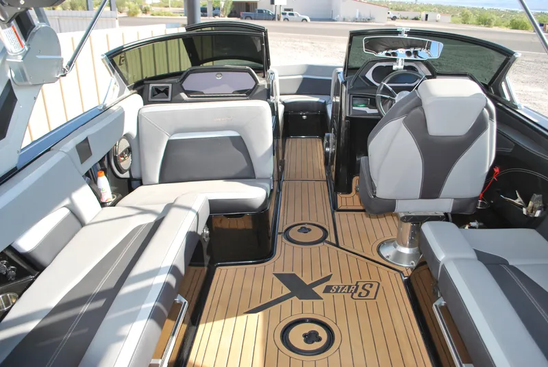 Slide: The Image of 2023 MasterCraft XStar S boat interior with sleek seating and modern dashboard design. - 10