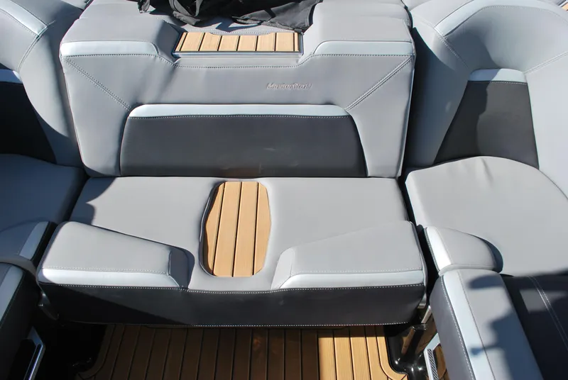 Slide: The Image of 2023 MasterCraft XStar S interior with gray seating and wooden accents. - 14