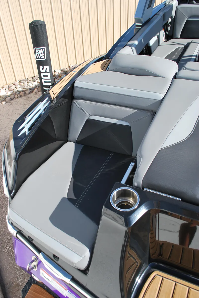 Slide: The Image of 2023 MasterCraft XStar S boat interior with gray seating and cup holder. - 16