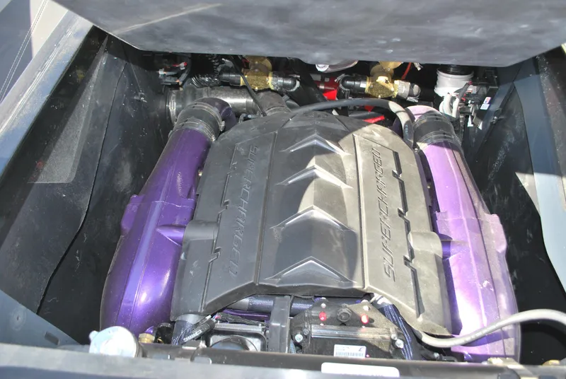 Slide: The Image of 2023 MasterCraft XStar S engine compartment with purple accents. - 18