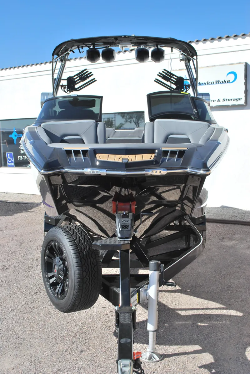 Slide: The Image of 2023 MasterCraft XStar S boat on trailer, front view, in outdoor setting. - 3