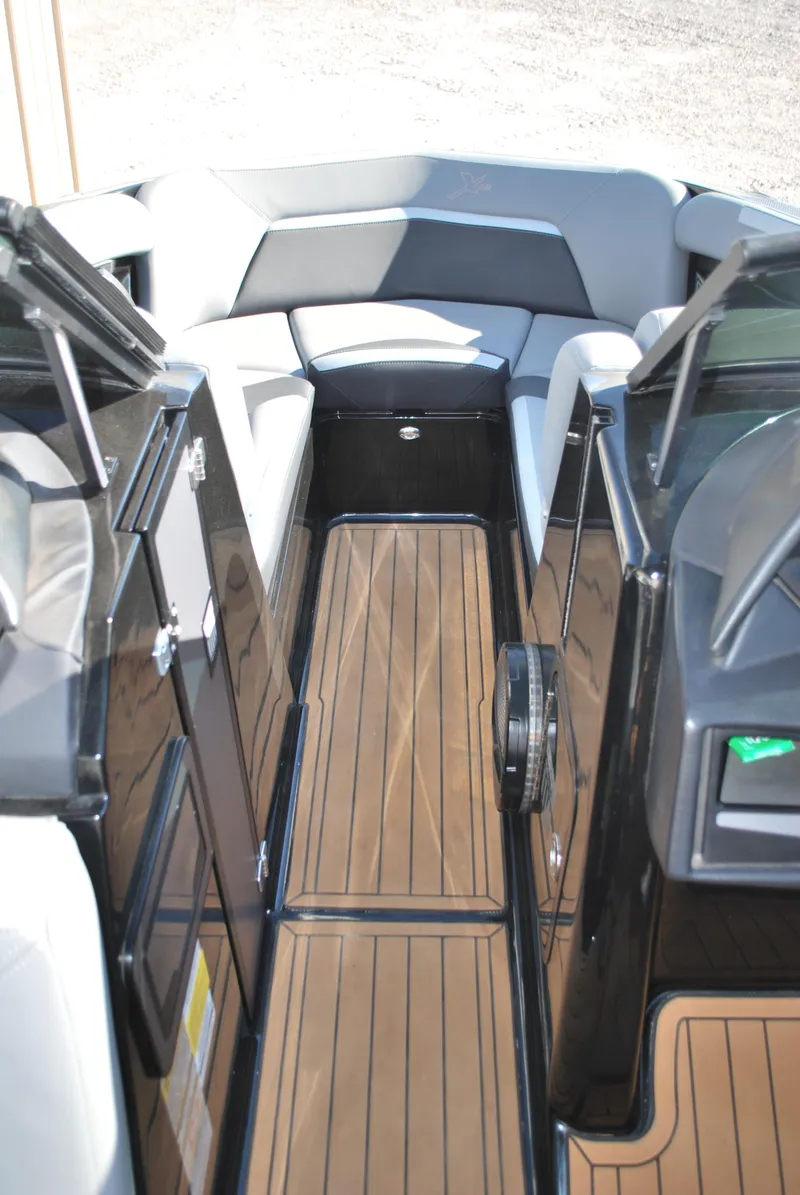 Slide: The Image of 2023 MasterCraft XStar S boat interior with sleek seating and wood flooring. - 8