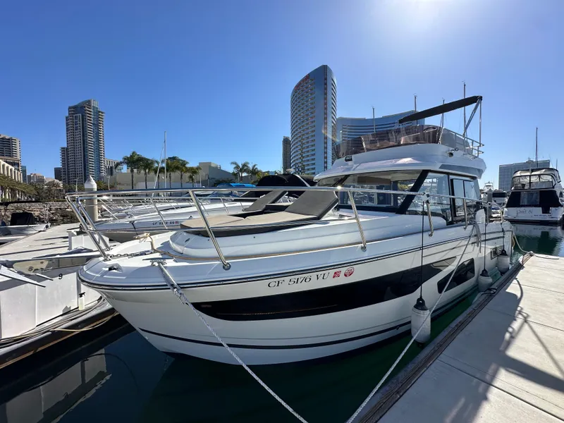 Slide: The Image of 2021 Jeanneau NC 1095 Fly yacht docked in urban marina setting. - 1