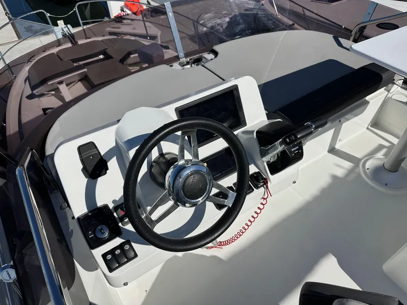 Slide: The Image of Flybridge helm of 2021 Jeanneau NC 1095 Fly with steering wheel and controls. - 15