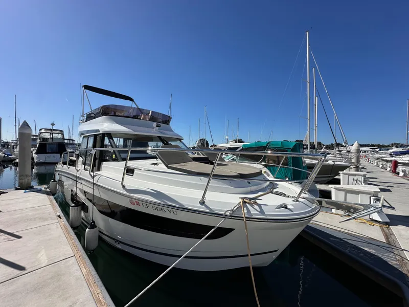 Slide: The Image of 2021 Jeanneau NC 1095 Fly yacht docked at marina under clear blue sky. - 3