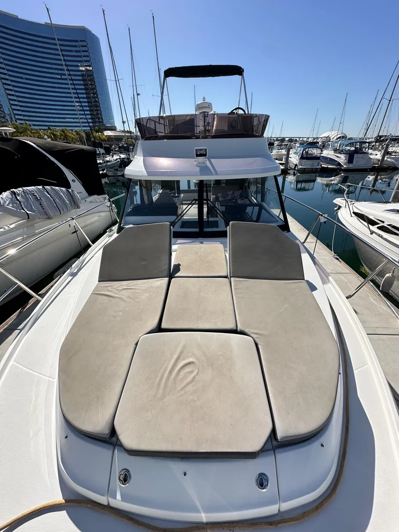 Slide: The Image of 2021 Jeanneau NC 1095 Fly yacht with sunbathing area, docked in a marina. - 32