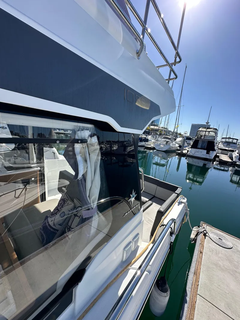 Slide: The Image of 2021 Jeanneau NC 1095 Fly yacht docked at marina under clear blue sky. - 35