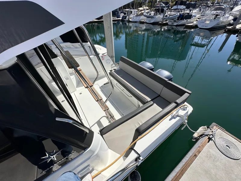 Slide: The Image of 2021 Jeanneau NC 1095 Fly at marina, featuring spacious seating and sleek design. - 36