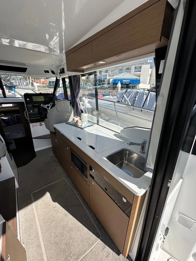 Slide: The Image of 2021 Jeanneau NC 1095 Fly interior with modern kitchen and sleek design. - 38
