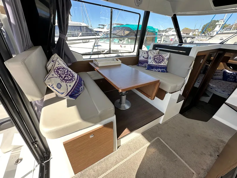Slide: The Image of Interior of 2021 Jeanneau NC 1095 Fly with seating and table, docked at marina. - 39