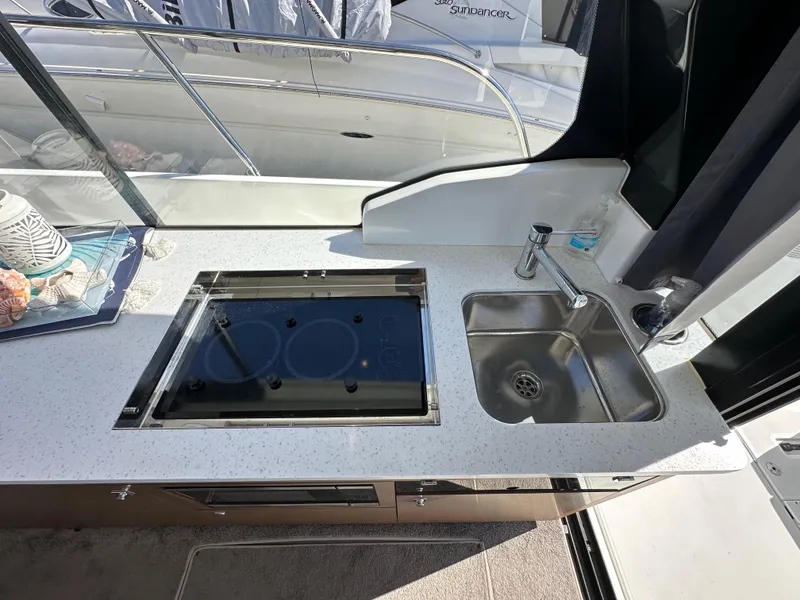 Slide: The Image of Modern kitchen area on 2021 Jeanneau NC 1095 Fly yacht with stove and sink. - 43