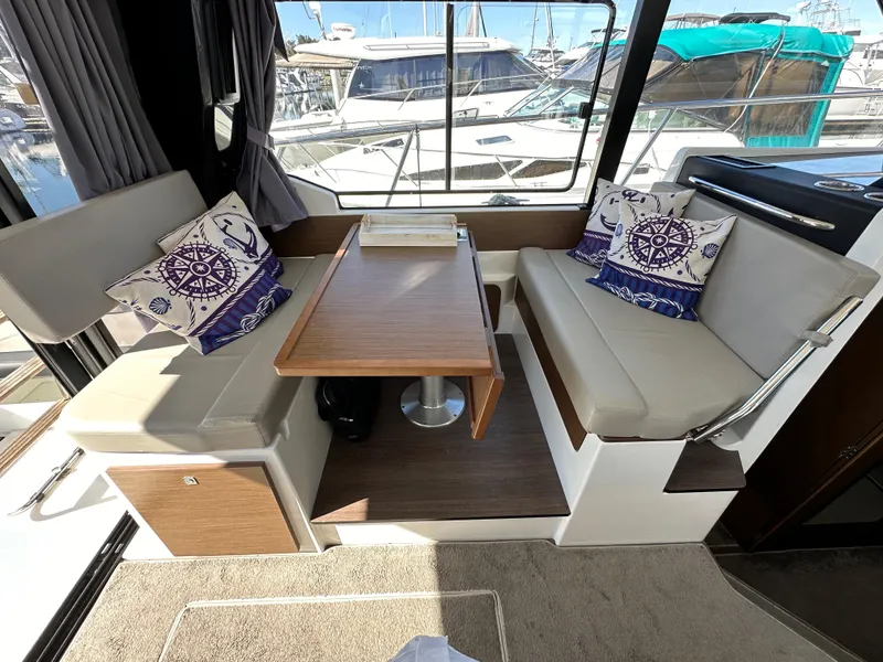 Slide: The Image of Interior of 2021 Jeanneau NC 1095 Fly with seating and nautical-themed cushions. - 45