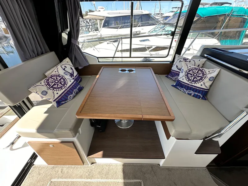 Slide: The Image of Interior of 2021 Jeanneau NC 1095 Fly with cozy seating and nautical-themed cushions. - 46