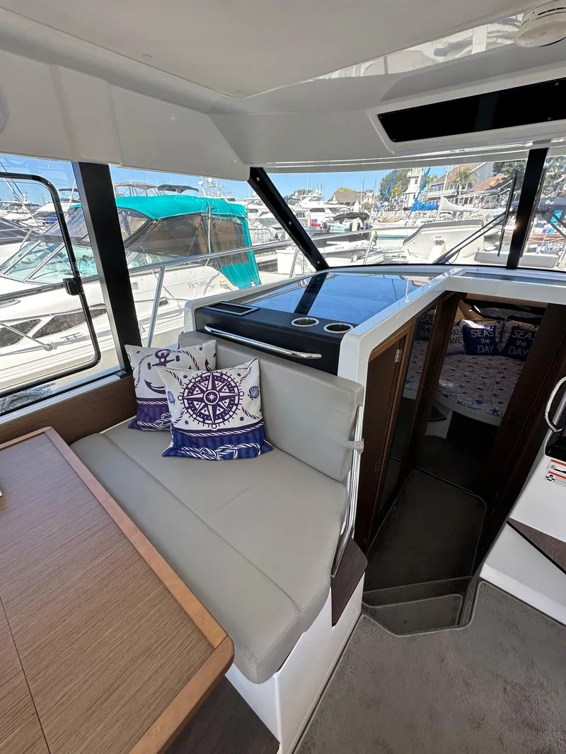 Slide: The Image of Interior of 2021 Jeanneau NC 1095 Fly, featuring seating and nautical-themed decor. - 47