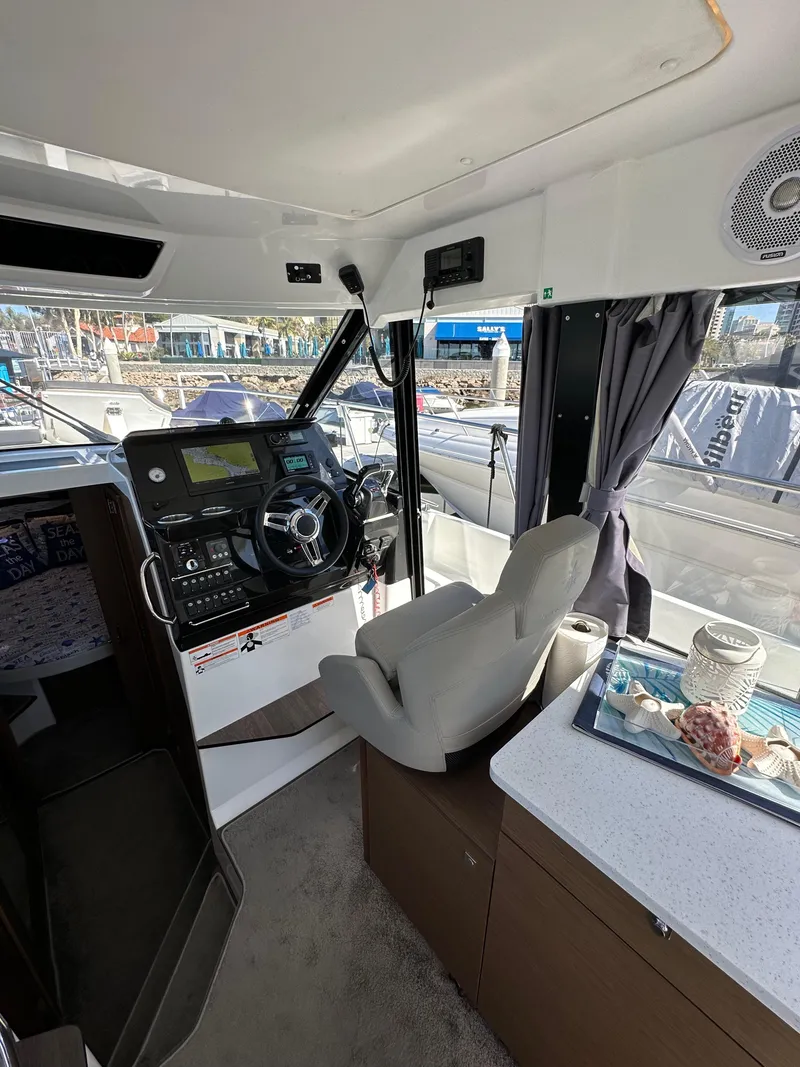 Slide: The Image of Interior of 2021 Jeanneau NC 1095 Fly boat with helm and seating area. - 49