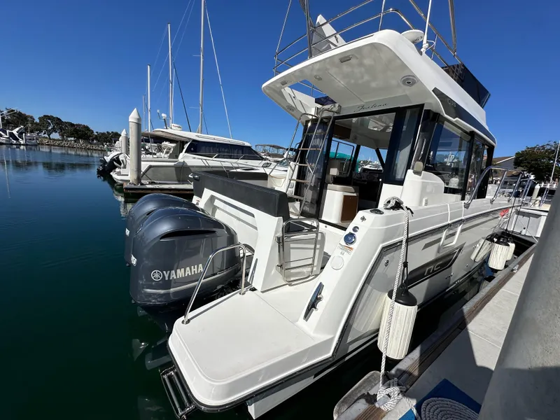 Slide: The Image of 2021 Jeanneau NC 1095 Fly yacht docked, featuring Yamaha outboard engines. - 8