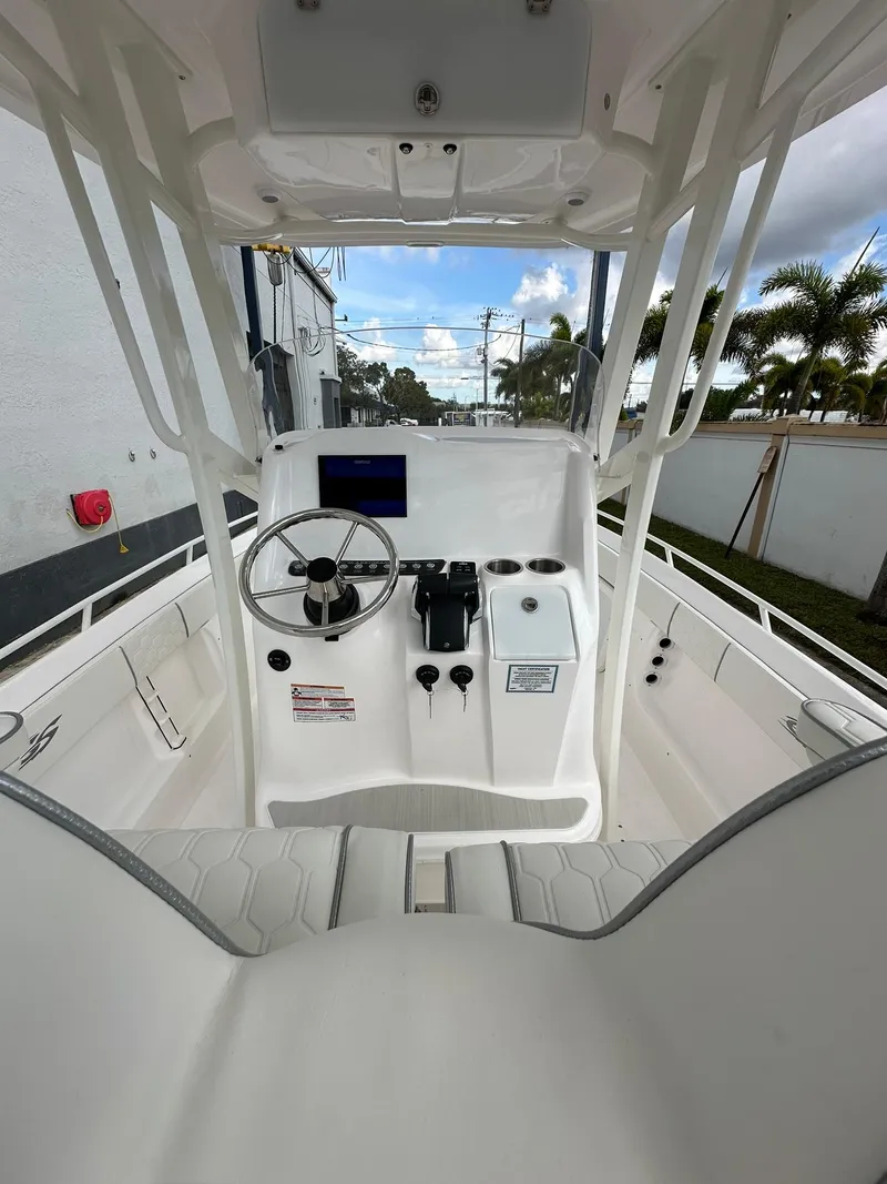 Slide: The Image of 2025 Glasstream 28 Pro boat cockpit with steering wheel and control panel. - 12