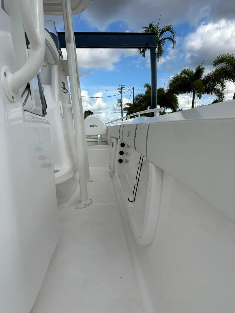 Slide: The Image of 2025 Glasstream 28 Pro boat deck with palm trees and cloudy sky background. - 9