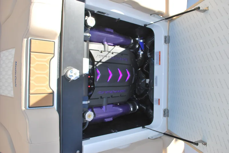 Slide: The Image of 2025 MasterCraft XT25 engine compartment with purple accents and open hatch. - 14