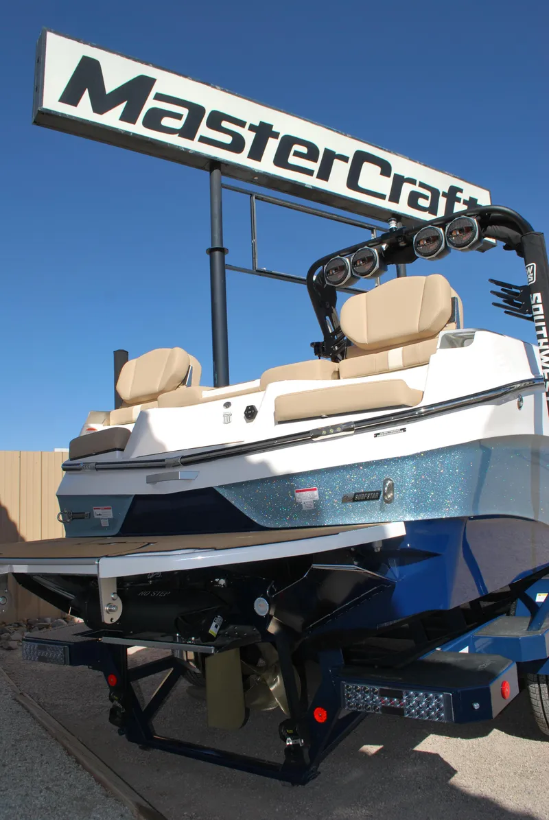 Slide: The Image of 2025 MasterCraft XT25 boat displayed under MasterCraft sign, featuring sleek design and seating. - 15