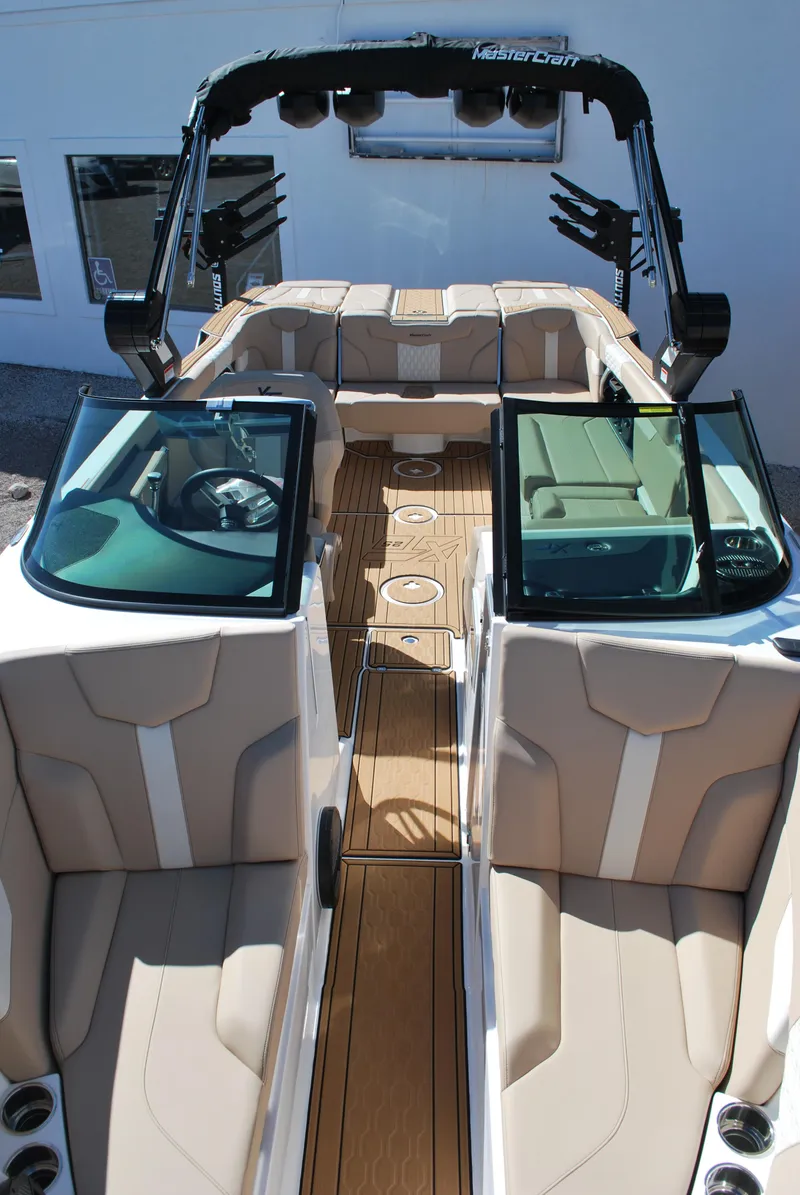 Slide: The Image of 2025 MasterCraft XT25 boat interior with beige seating and sleek design. - 3