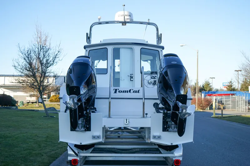 Slide: The Image of 2025 C-Dory 25' Tomcat Catamaran with dual engines, rear view on a trailer. - 4
