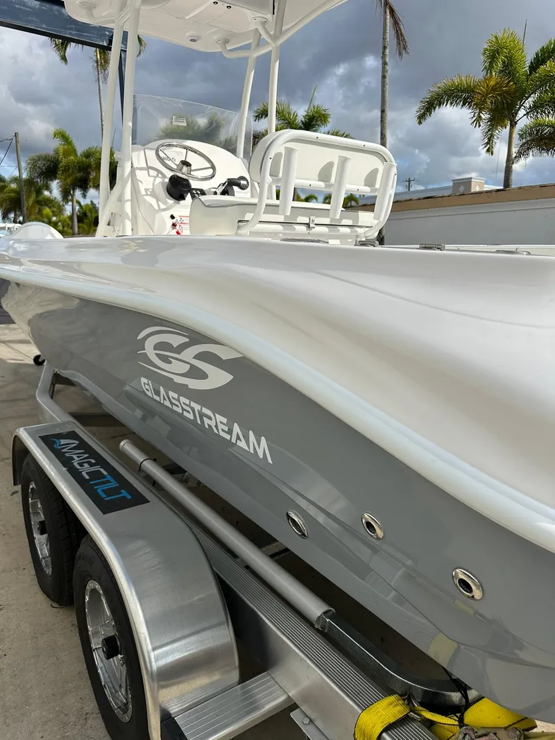 Slide: The Image of 2025 Glasstream 240 CCX boat on trailer, sleek design, palm trees in background. - 10