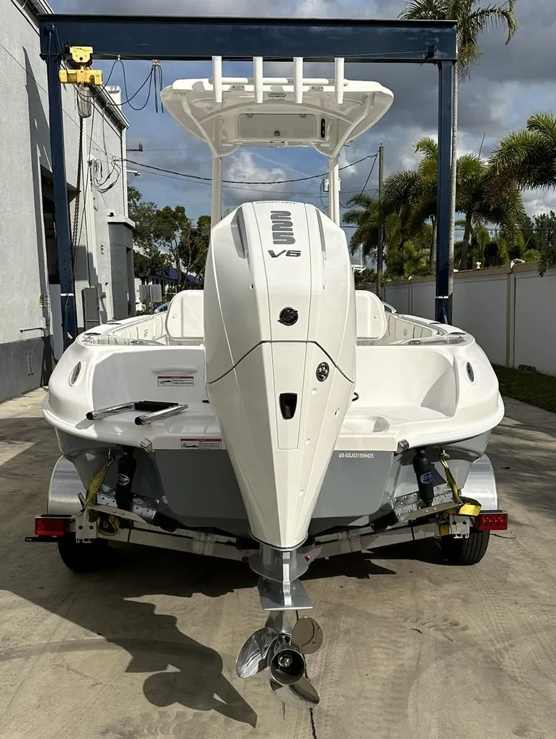 Slide: The Image of 2025 Glasstream 240 CCX boat with V6 engine, parked outdoors. - 4